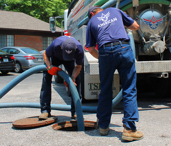 Professional service on grease trap in parking lot